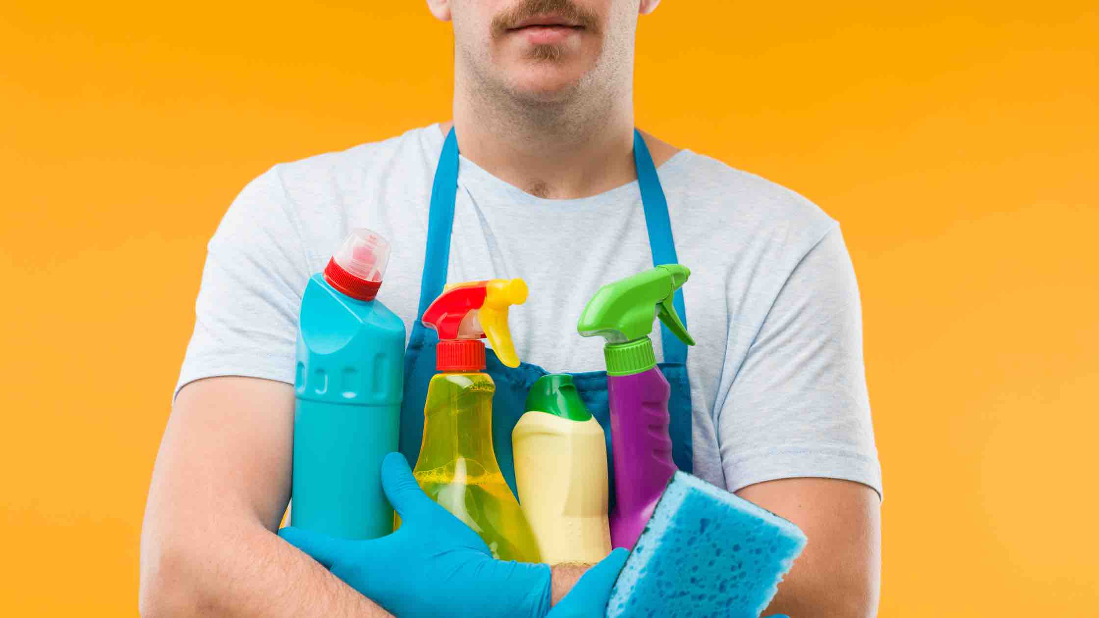man holding cleaning supplies 