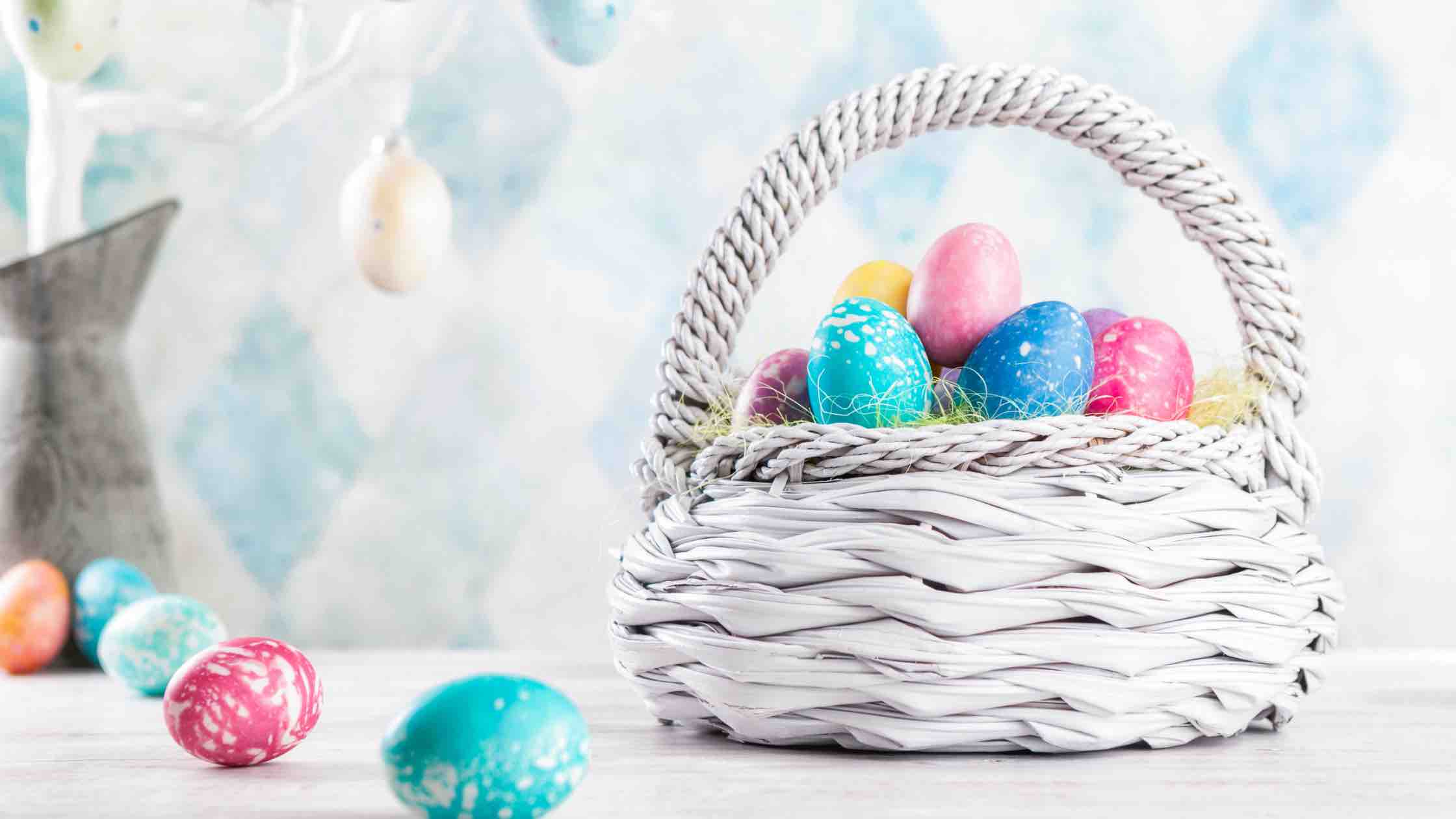Easter basket filled with colored eggs