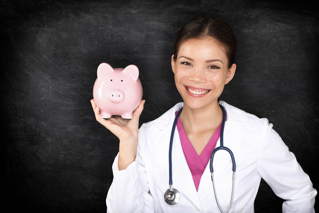 picture of a nurse holding a piggy bank saving money