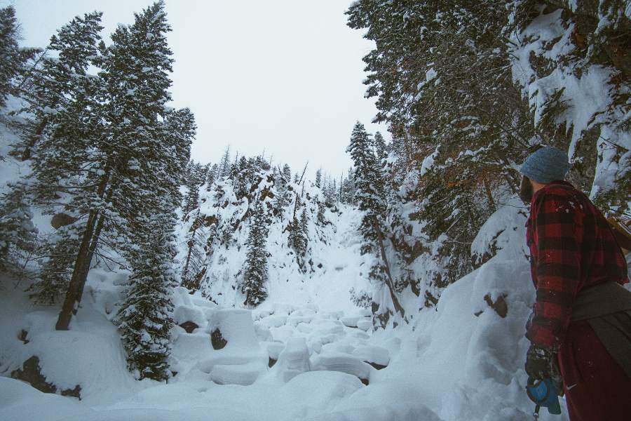 nurse on day off standing in Colorado trees and snow