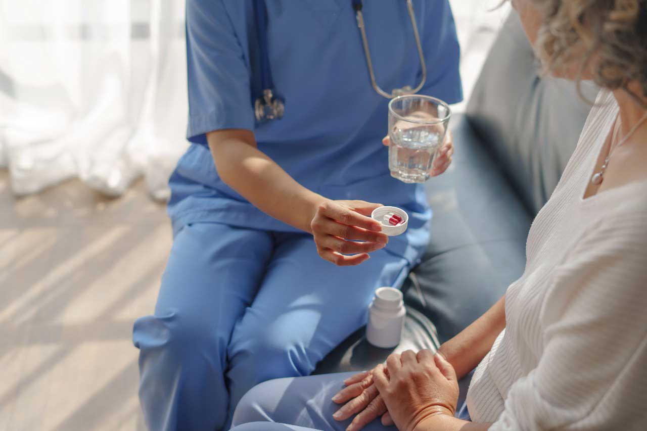 Medication aide with her patient