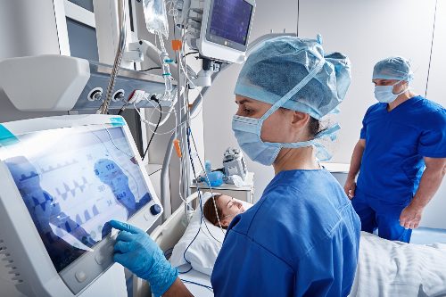 Two ICU nurses in Salt Lake City working with patient