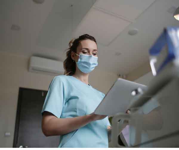 LPN holding clipboard in doctor office