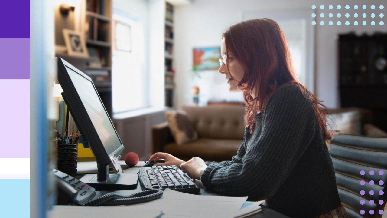 A woman looking at a computer in a home setting