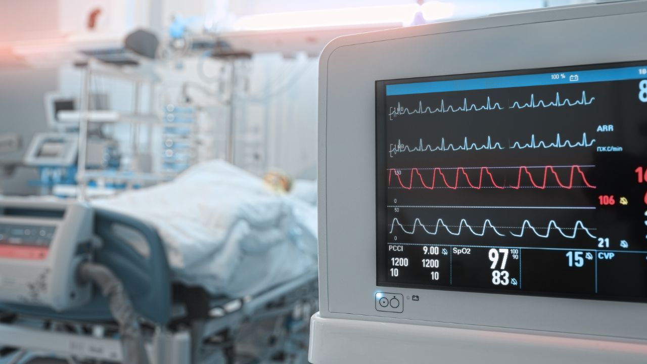 a room with machines for a surgery and one patient