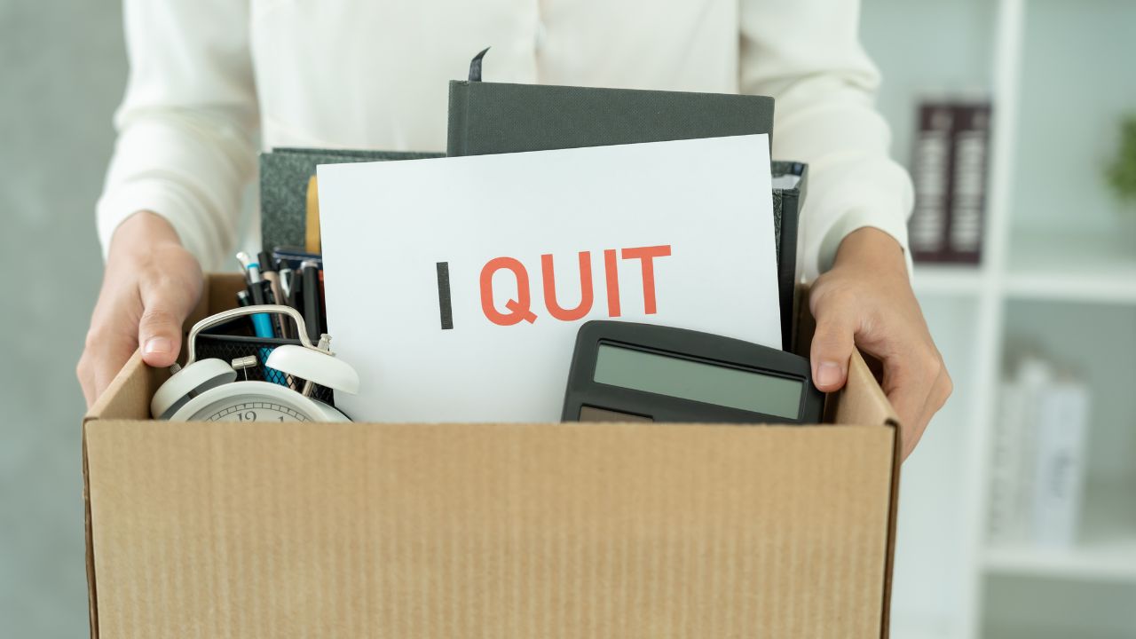 a person with a box and work belongings