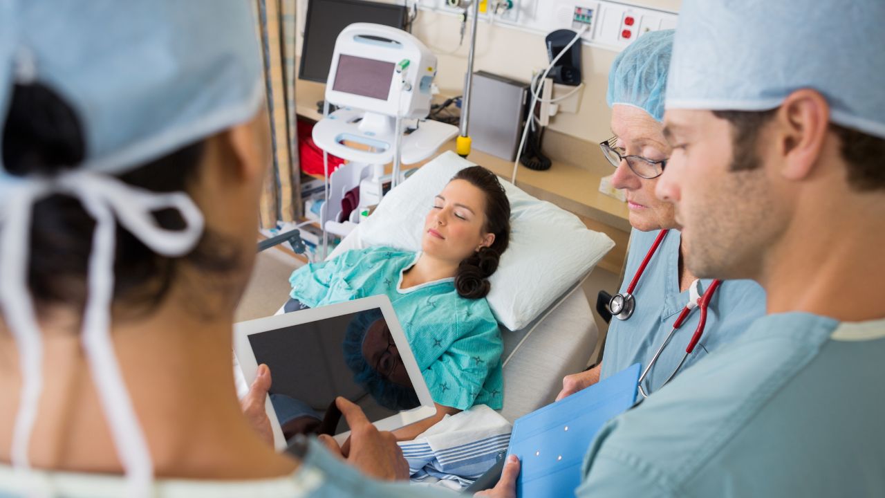 some nurses checking a patient 