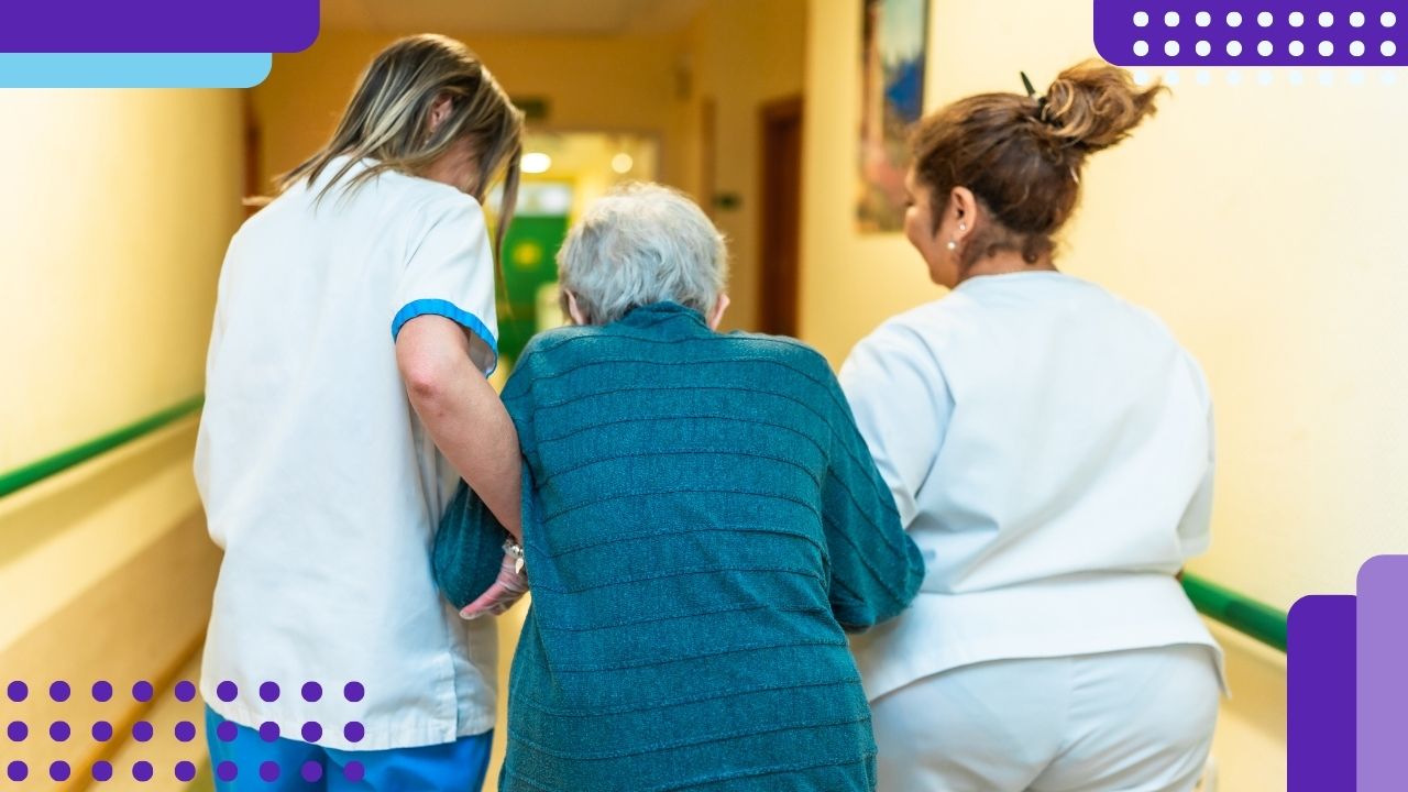 Two nurses helping an elderly patient walk