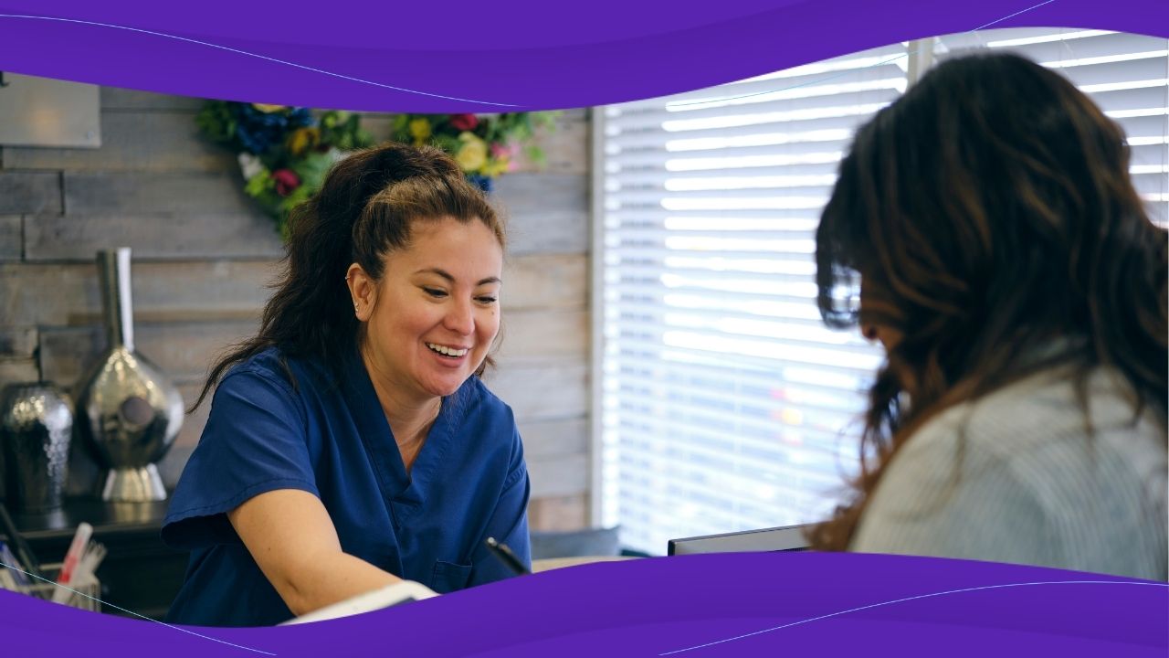 A patient being helped by a healthcare professional at a receptionist's desk
