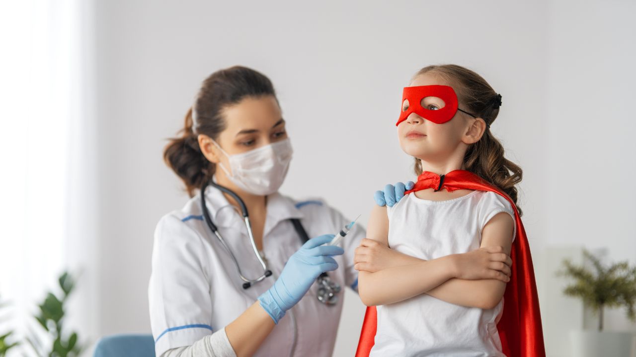 little girl being vaccinated by a nurse